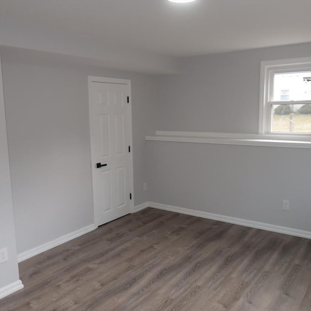 empty room featuring dark wood-type flooring