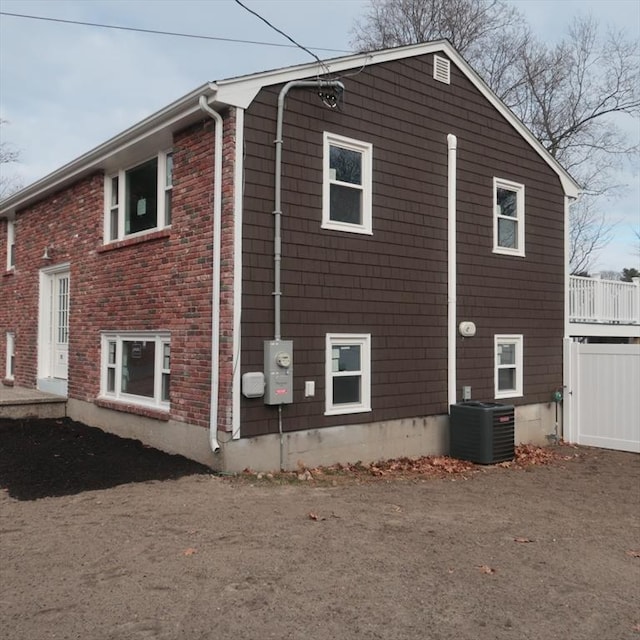 view of side of property featuring central air condition unit