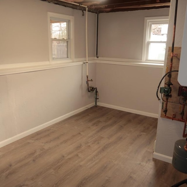 basement featuring a wealth of natural light and wood-type flooring