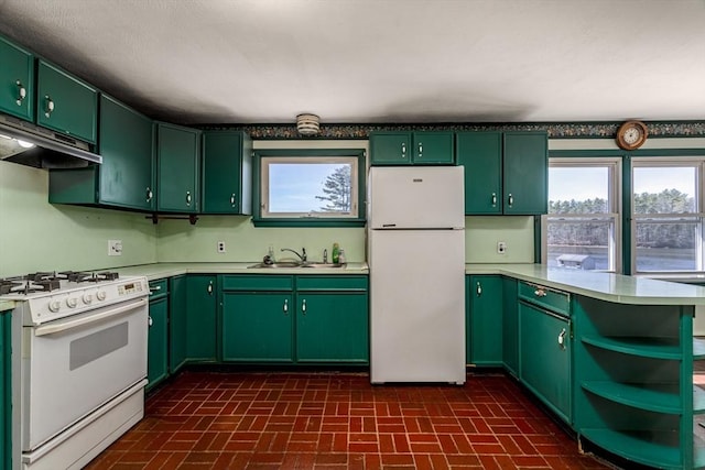 kitchen with light countertops, brick patterned floor, green cabinetry, and white appliances