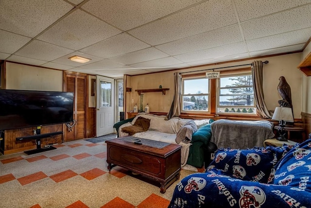 living area with a drop ceiling
