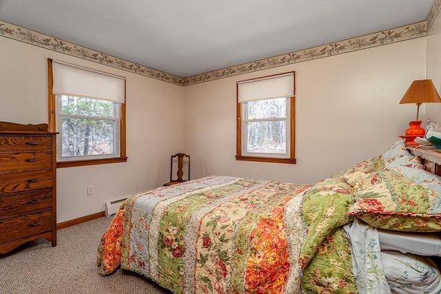 bedroom featuring baseboards, baseboard heating, and carpet flooring