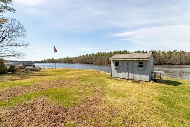 view of yard with an outdoor structure, a storage unit, and a water view