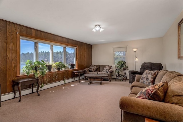 carpeted living room featuring a baseboard radiator and wood walls