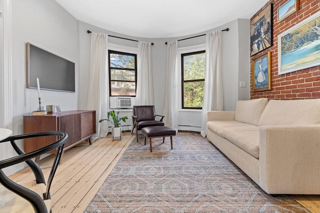 81 E Brookline St Unit 3, Boston, MA 02118 - living area featuring a baseboard heating unit, hardwood / wood-style floors, cooling unit, and an accent wall