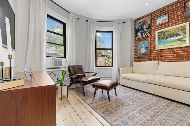 81 E Brookline St Unit 3, Boston, MA 02118 - living area with plenty of natural light, brick wall, hardwood / wood-style flooring, cooling unit, and an accent wall