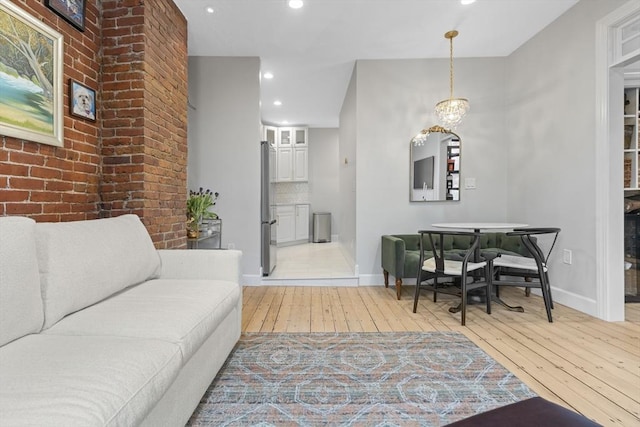 81 E Brookline St Unit 3, Boston, MA 02118 - living area featuring light wood-style floors, recessed lighting, baseboards, a chandelier, and brick wall