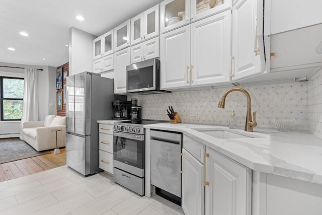 81 E Brookline St Unit 3, Boston, MA 02118 - kitchen with appliances with stainless steel finishes, a sink, white cabinetry, tasteful backsplash, and recessed lighting