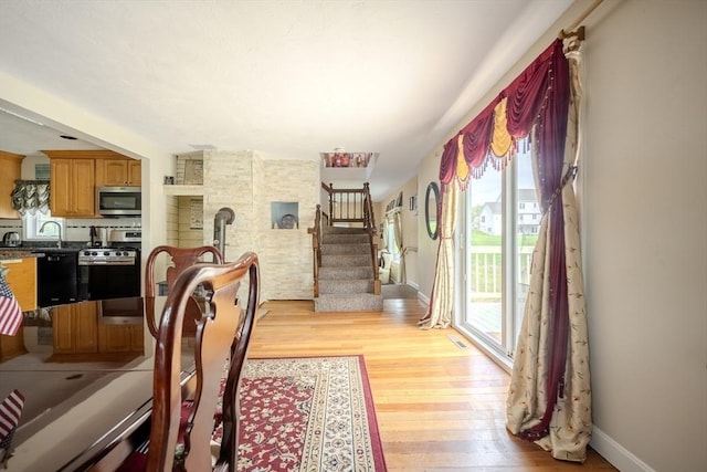 342 Townsend Rd, Groton, MA 01450 - dining area with healthy amount of natural light, light wood finished floors, stairway, and baseboards