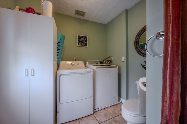 342 Townsend Rd, Groton, MA 01450 - laundry room featuring washing machine and dryer, a textured ceiling, light tile patterned floors, and baseboards