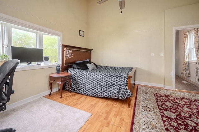 342 Townsend Rd, Groton, MA 01450 - bedroom featuring baseboards, wood finished floors, multiple windows, and a towering ceiling