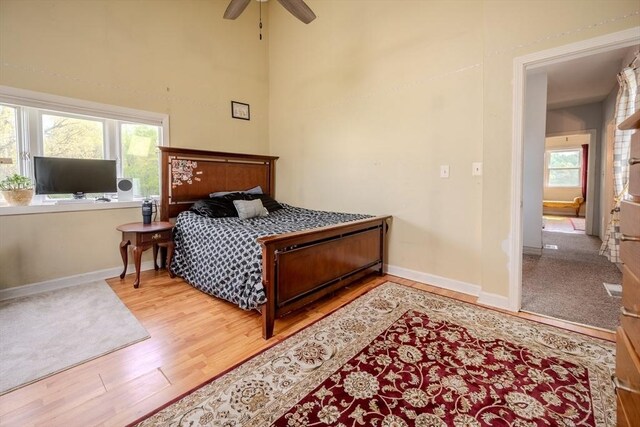 342 Townsend Rd, Groton, MA 01450 - bedroom featuring wood finished floors, baseboards, multiple windows, a high ceiling, and a ceiling fan
