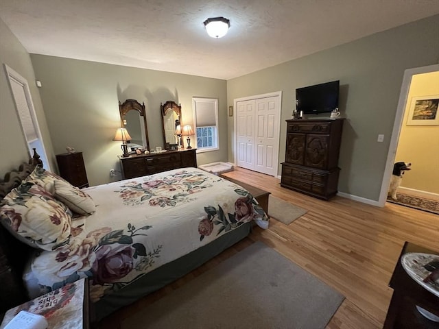 bedroom with a closet and light hardwood / wood-style floors