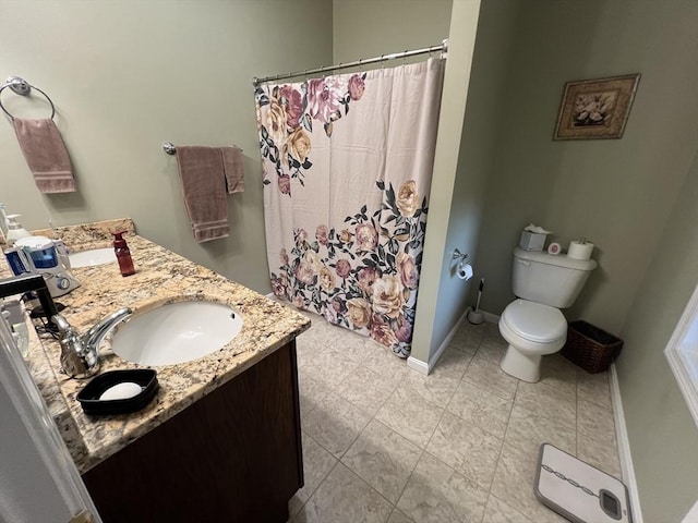 bathroom featuring toilet, vanity, and a shower with curtain