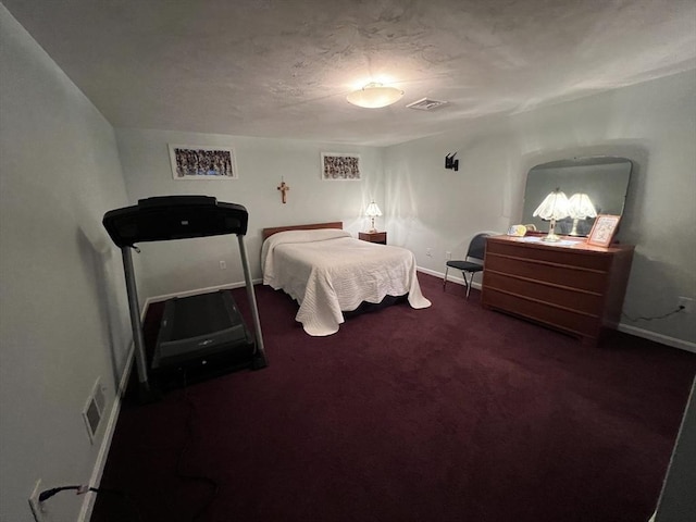 carpeted bedroom featuring a textured ceiling