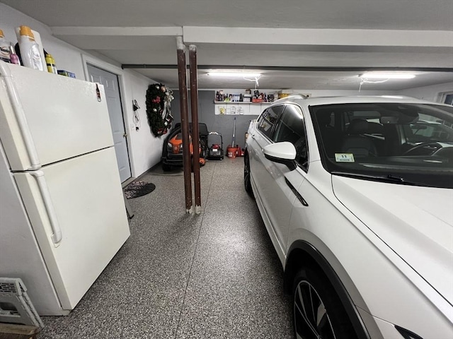 garage featuring white fridge