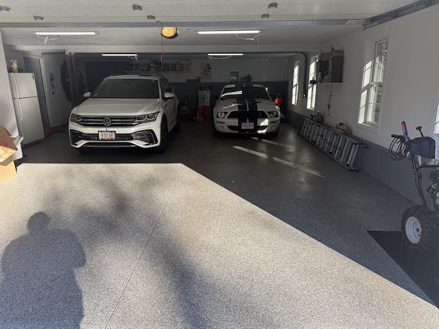 garage with white fridge and a garage door opener