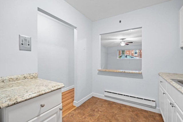 18 Pond St Unit 2, Boston, MA 02130 - kitchen featuring a baseboard heating unit, a ceiling fan, and white cabinetry