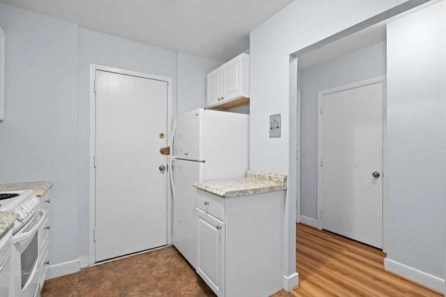 18 Pond St Unit 2, Boston, MA 02130 - kitchen with white cabinets, light countertops, white appliances, and baseboards
