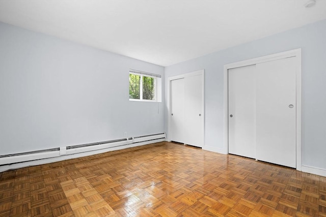 18 Pond St Unit 2, Boston, MA 02130 - unfurnished bedroom with two closets, a baseboard radiator, and baseboards