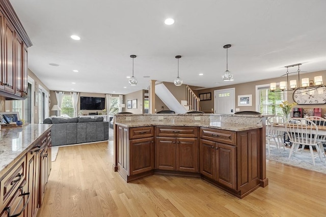4 Elizabeth Rd, Hudson, MA 01749 - kitchen featuring light wood finished floors, decorative light fixtures, light stone countertops, recessed lighting, and open floor plan