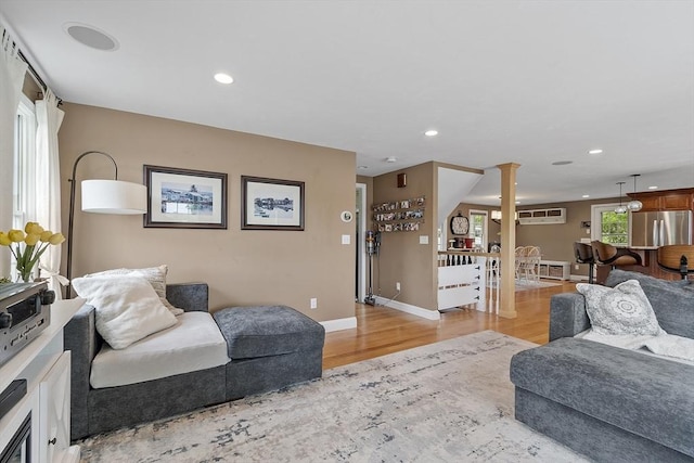4 Elizabeth Rd, Hudson, MA 01749 - living area featuring ornate columns, light wood-style floors, recessed lighting, baseboards, and a wall mounted AC