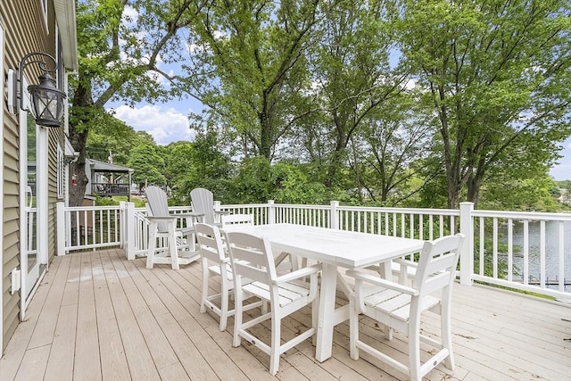 4 Elizabeth Rd, Hudson, MA 01749 - wooden terrace featuring outdoor dining area and view of wooded area