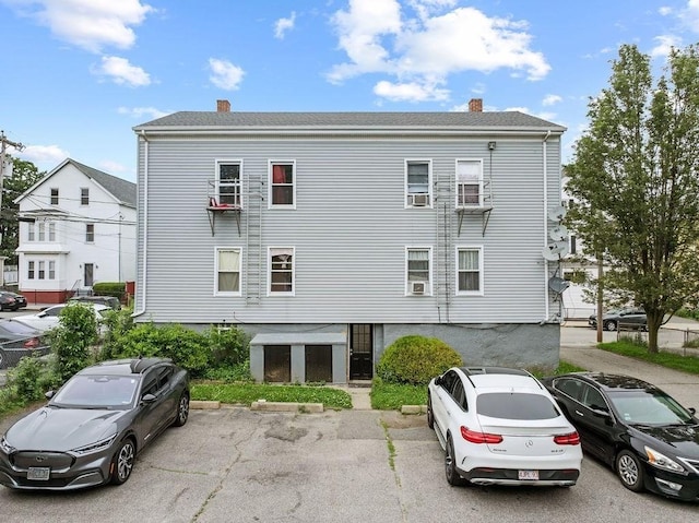 135 Snell, Fall River, MA 02721 - view of property exterior with a chimney and uncovered parking
