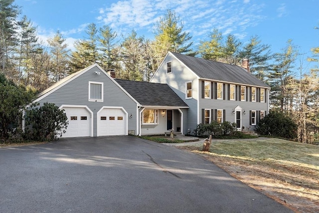 view of front of property with a garage and a front yard