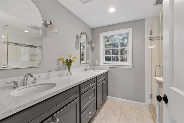 bathroom featuring vanity and an enclosed shower