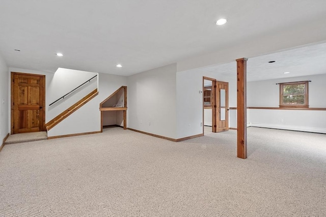 interior space featuring light colored carpet and a baseboard heating unit