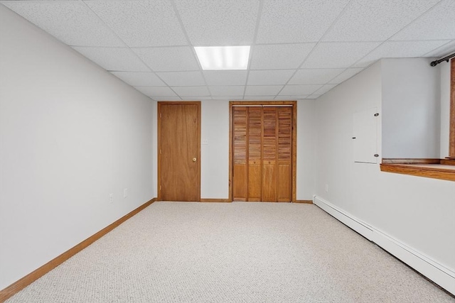 carpeted bedroom with a baseboard heating unit