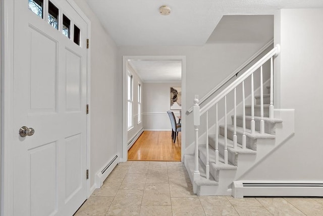 entrance foyer with a healthy amount of sunlight and a baseboard heating unit