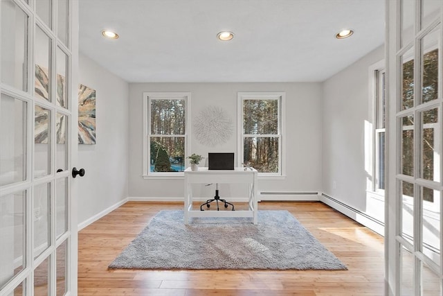 office featuring light hardwood / wood-style flooring, a baseboard radiator, and french doors