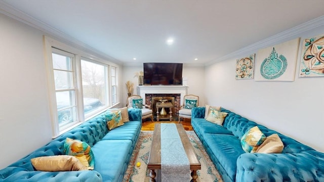 living room featuring a brick fireplace, ornamental molding, and hardwood / wood-style floors