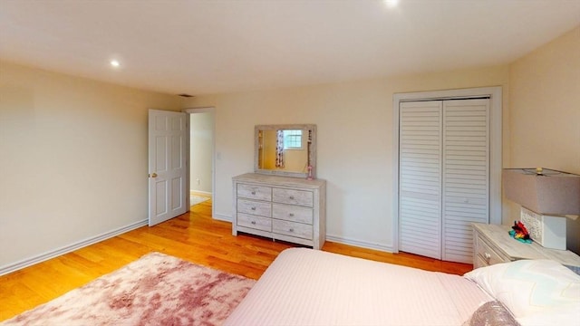 bedroom featuring light wood-type flooring and a closet