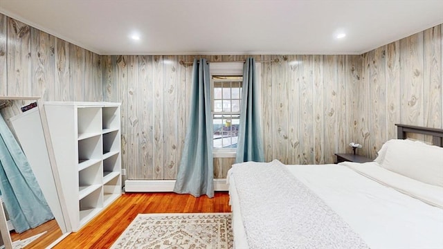 bedroom featuring a baseboard radiator and hardwood / wood-style flooring