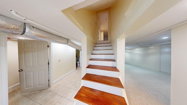 stairway featuring tile patterned floors