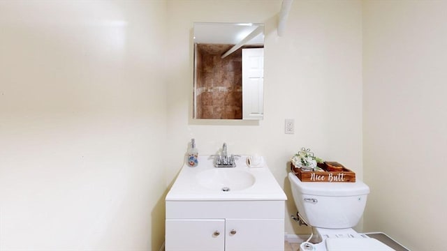 bathroom featuring toilet and vanity