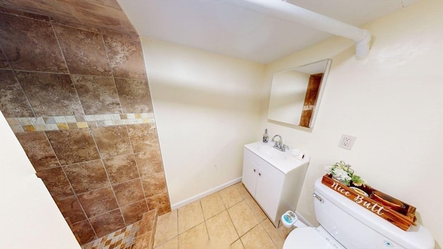 bathroom featuring toilet, vanity, and tile patterned flooring