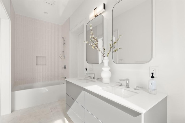 full bath with washtub / shower combination, a sink, marble finish floor, and double vanity