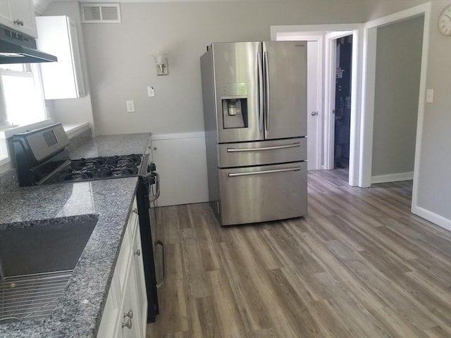 65 Reservoir St Unit 65, Holden, MA 01520 - kitchen with stainless steel fridge with ice dispenser, gas range oven, under cabinet range hood, white cabinetry, and light wood finished floors