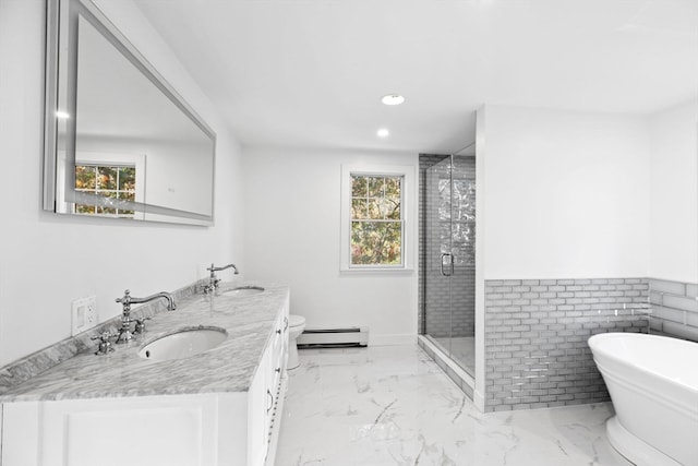 bathroom with vanity, baseboard heating, independent shower and bath, and tile walls