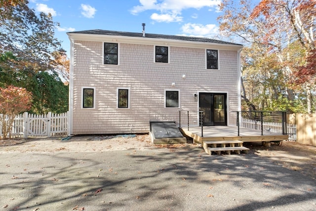 rear view of house featuring a deck