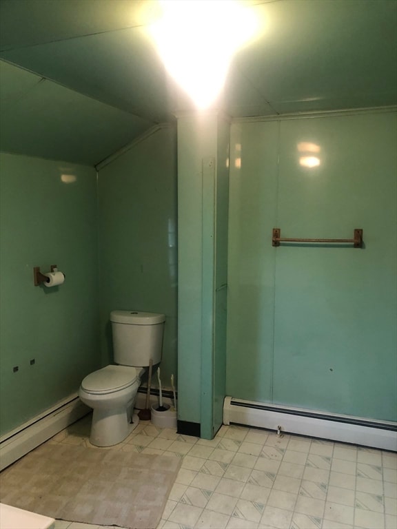 bathroom featuring toilet and a baseboard heating unit