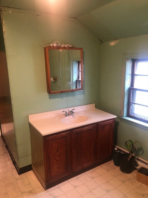 bathroom with vanity and vaulted ceiling