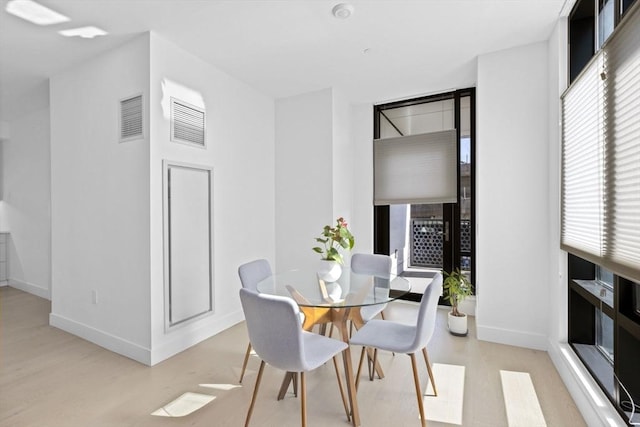 dining room with light hardwood / wood-style flooring