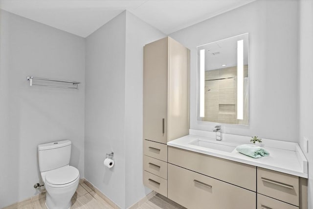 bathroom featuring toilet, vanity, and walk in shower