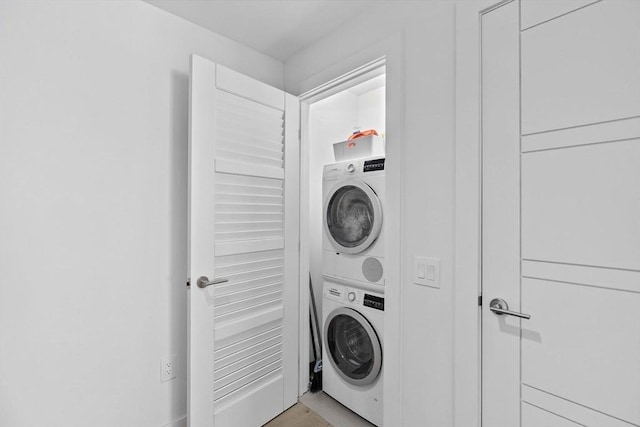 laundry area with stacked washing maching and dryer