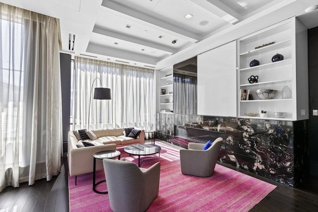 living room featuring wood-type flooring and built in features